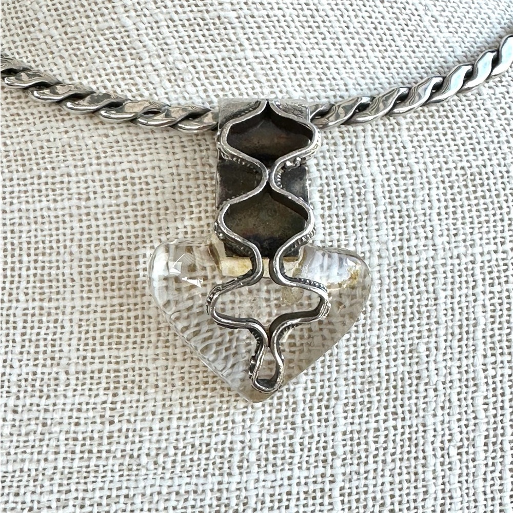 Transparent polished heart quartz stone w sterling silver zig zag design front
